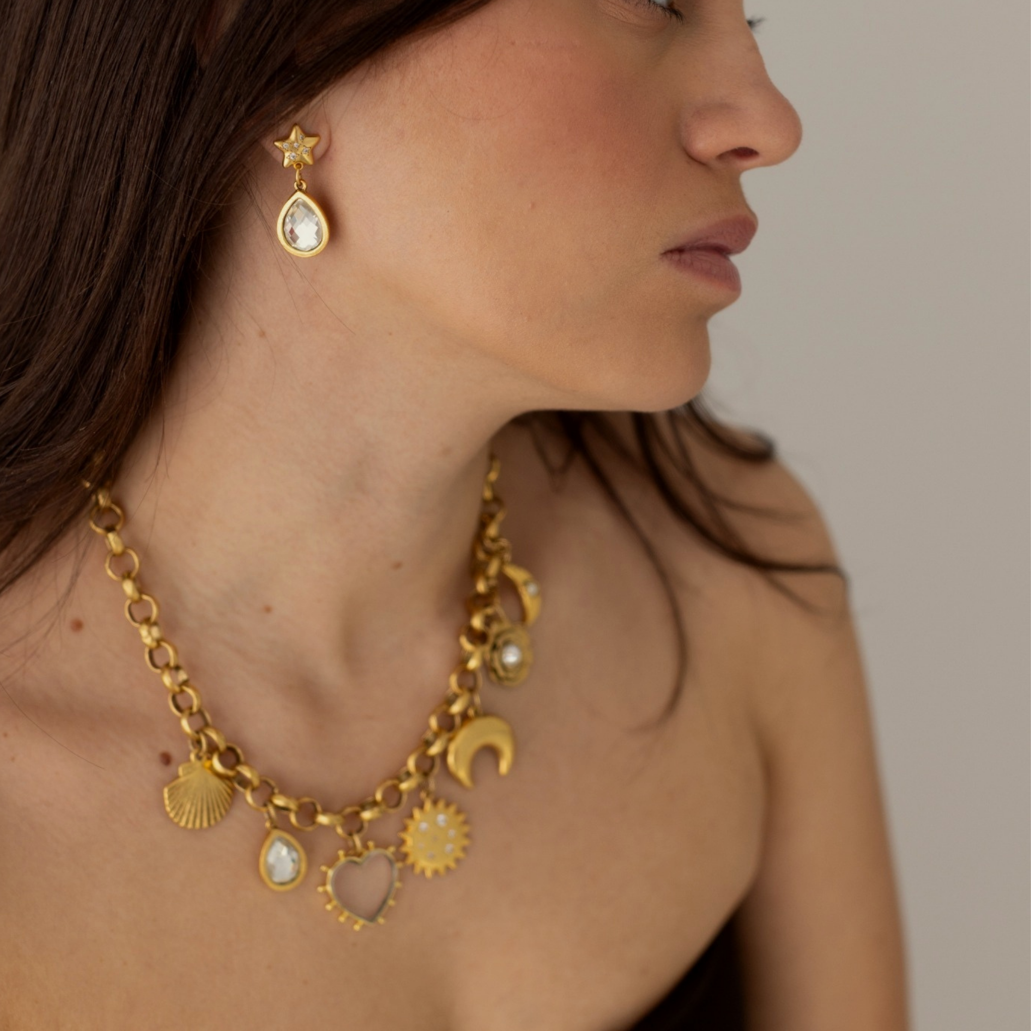 Model wearing Lanamara Celestial Crystal star drop earrings with the Celestial charm necklace