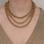 Lanamara Artisan hammered gold necklace shown layered in three lengths