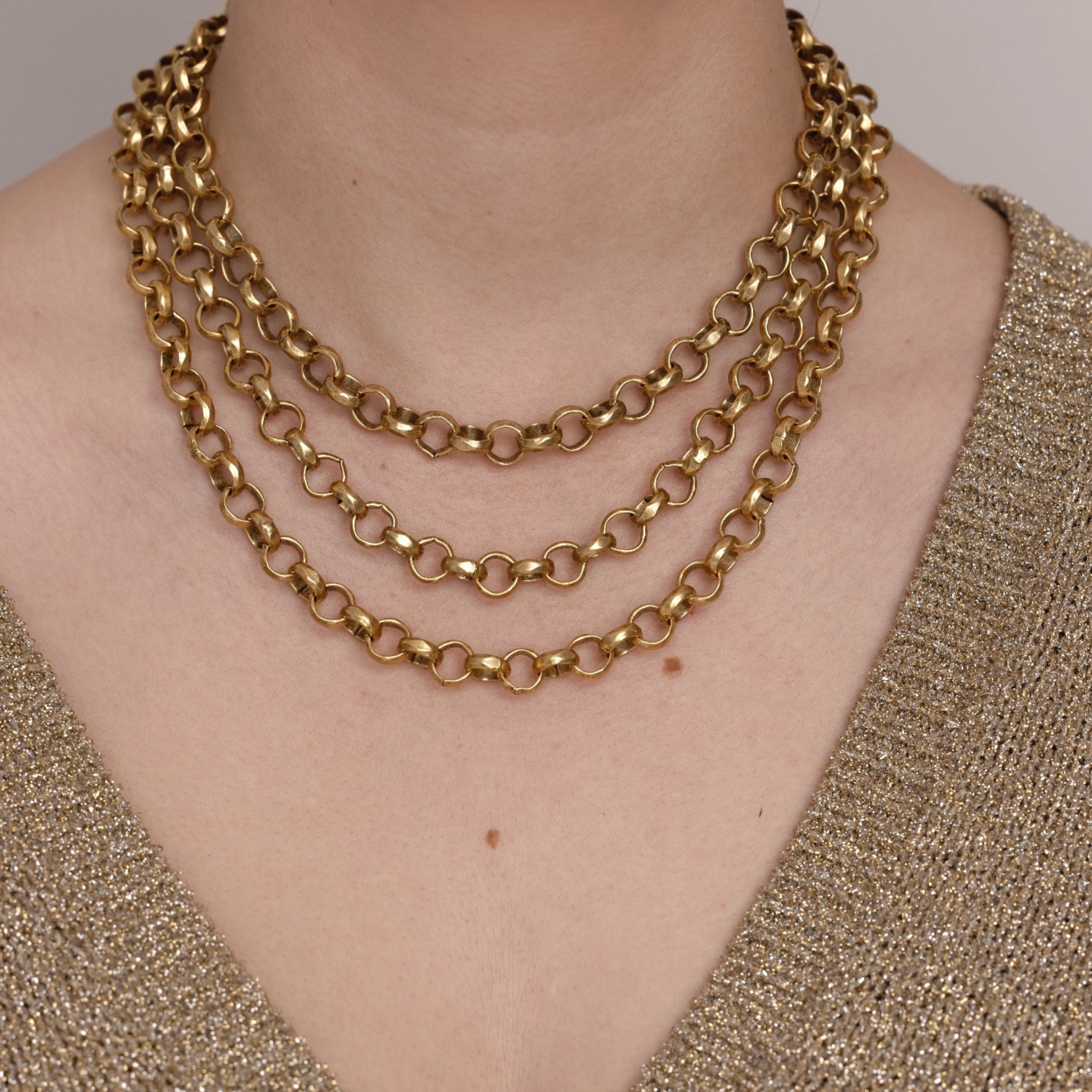 Lanamara Artisan hammered gold necklace shown layered in three lengths