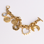 Lanamara Celestial Charm Bracelet in gold with seven talisman charms, flat lay