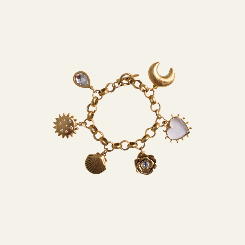 Lanamara Celestial Charm Bracelet — seven gold talisman charms including sun, moon, shell, heart and rose