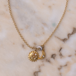 Close-up of Lanamara Celestial pendant — gold sunstar, crescent moon and pavé CZ charm cluster