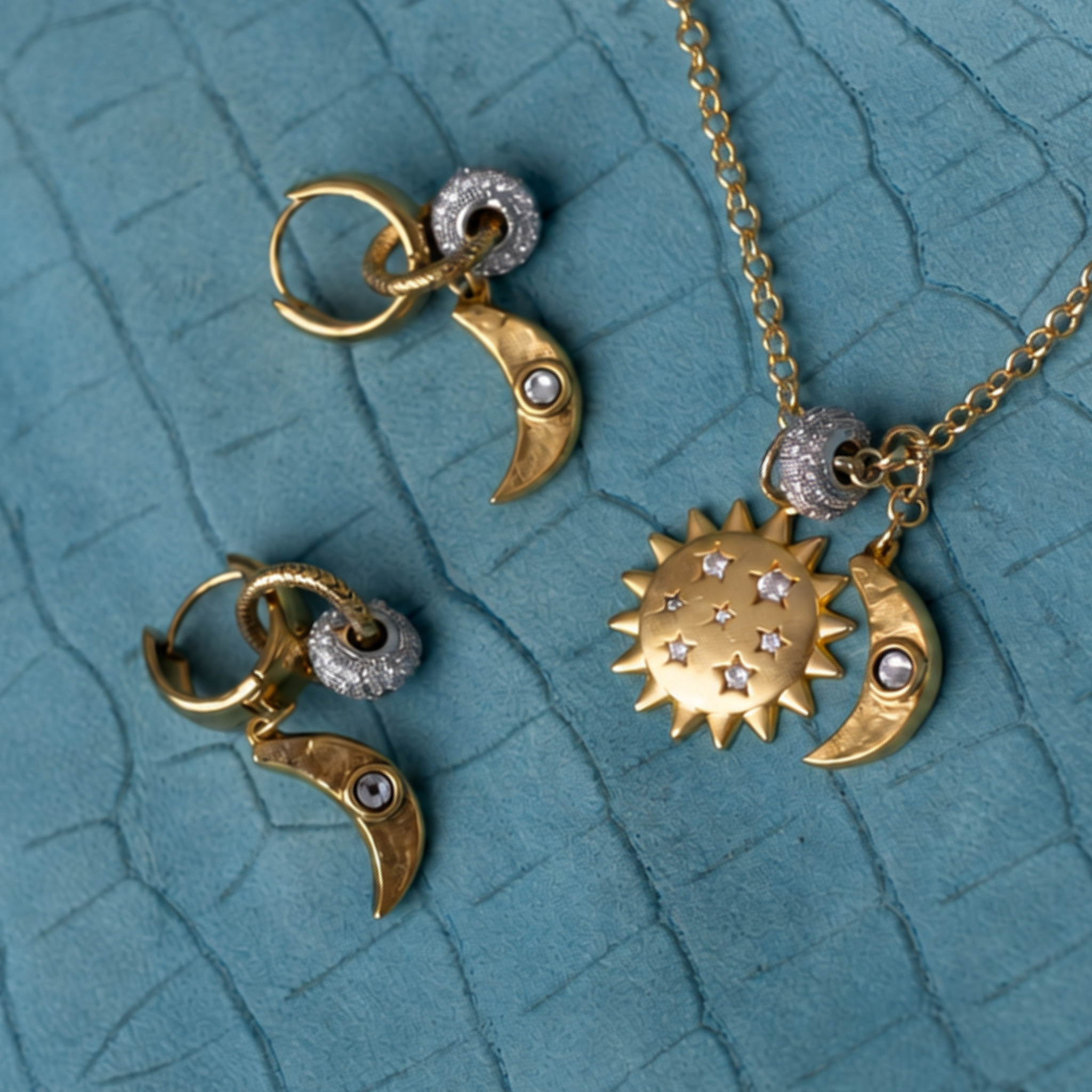 Lanamara Celestial pendant necklace with matching crescent moon earrings, styled on teal