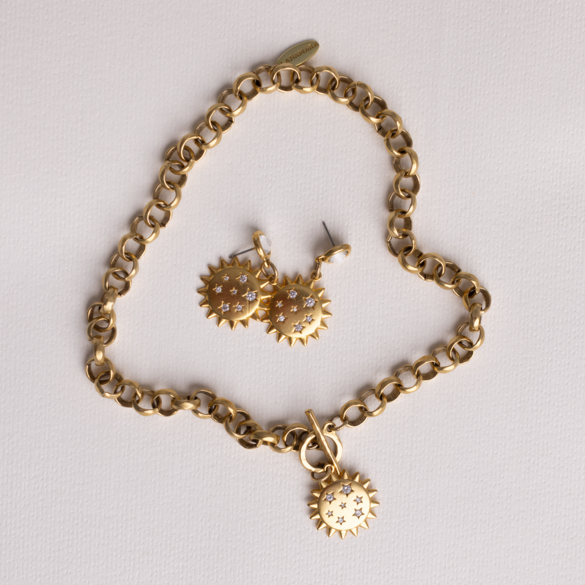 Lanamara Intuition Sunstar necklace and matching earrings flat lay on white