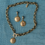 Lanamara Intuition Sunstar necklace and matching earrings styled on teal