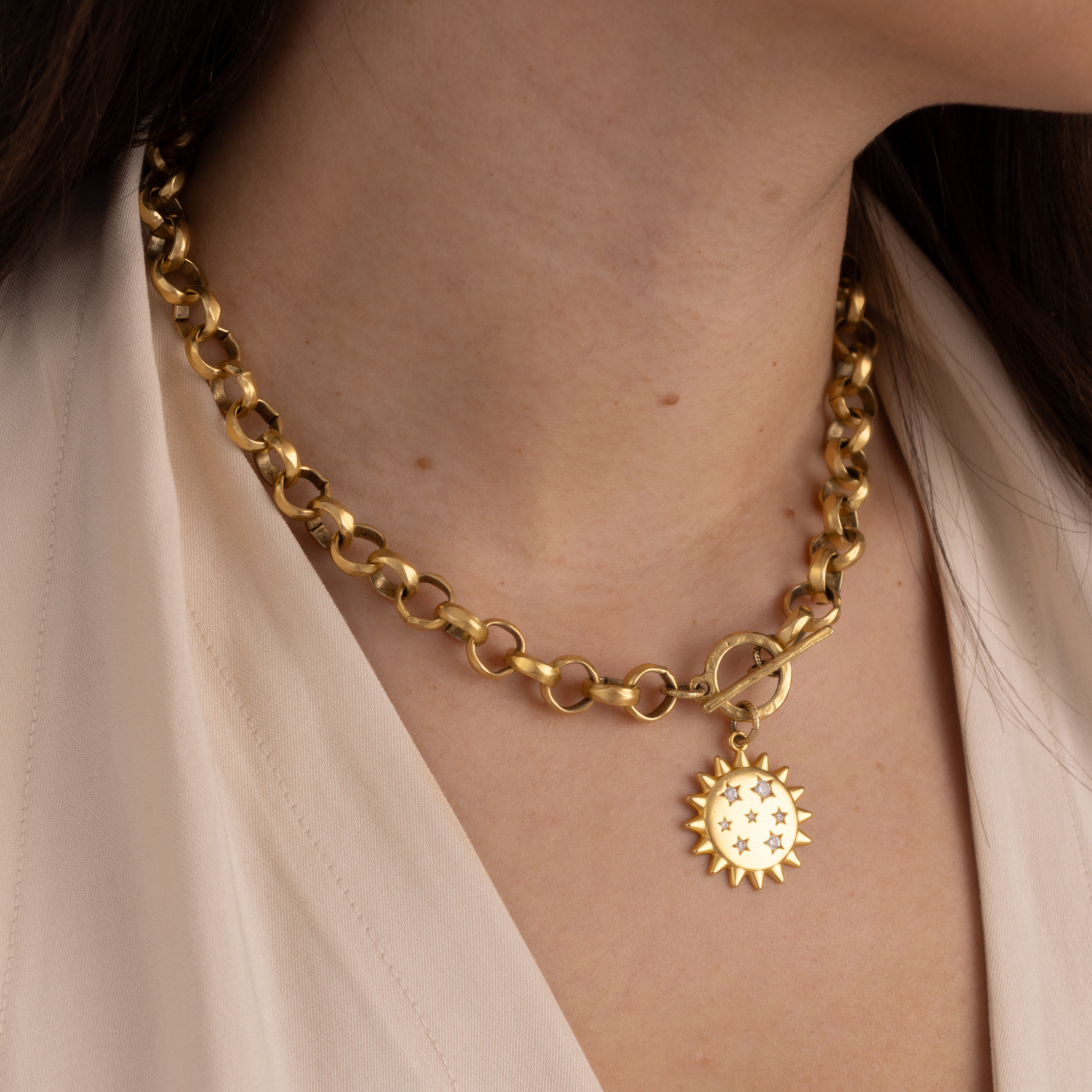Lanamara Intuition Sunstar necklace worn front, gold sun pendant with toggle clasp