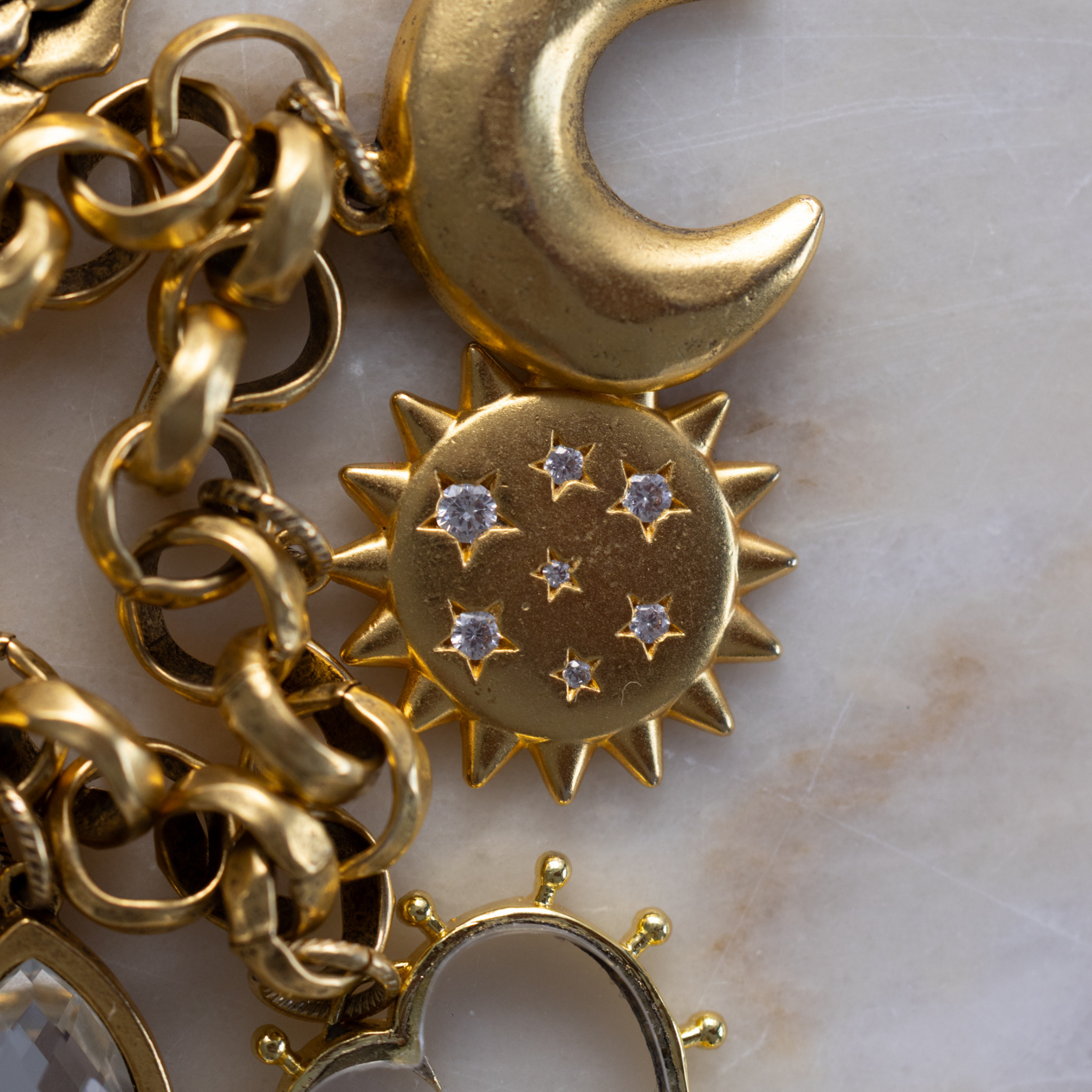 Close-up of Lanamara matte gold sunstar pendant with CZ-set stars on artisan chain