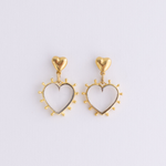 Lanamara open heart drop earrings in gold with a radiant beaded edge on a soft lilac background