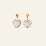Lanamara Open Hearted clear quartz and gold heart drop earrings on a cream background