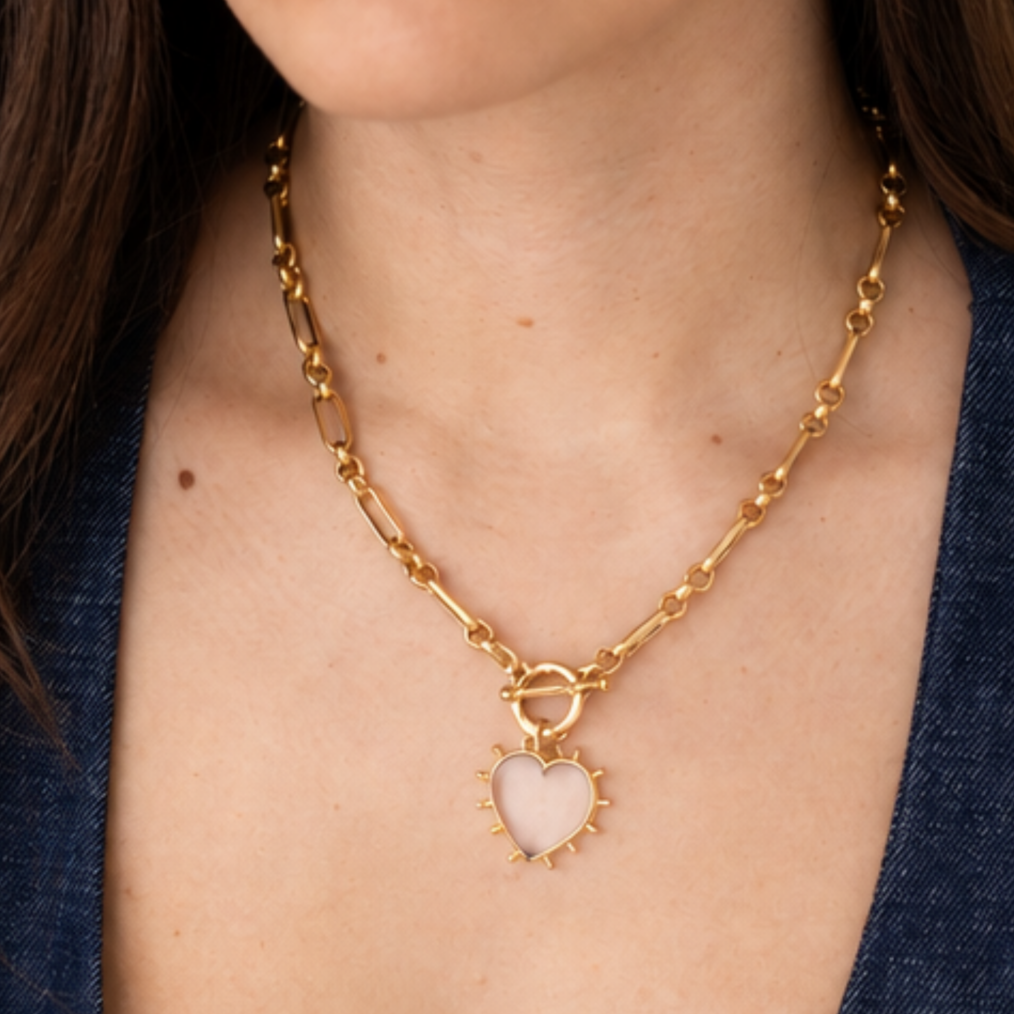 Model wearing Lanamara Open Hearted clear quartz heart necklace in gold