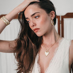 Model wearing the Lanamara Heart Stopper Necklace, a gold heart pendant on a paperclip chain