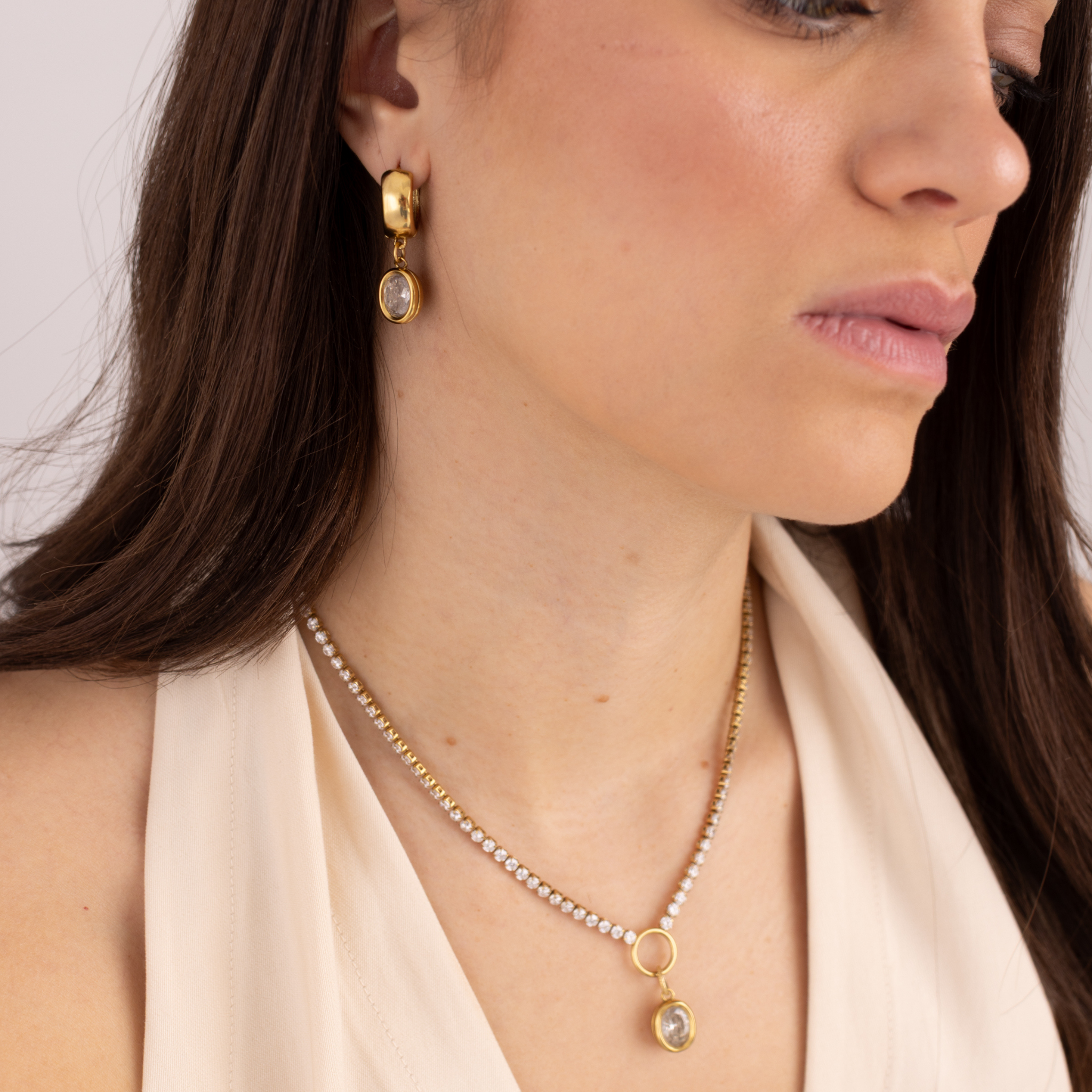 Model wearing Lanamara Vintage Clarity oval huggie earrings with the Clarity tennis necklace