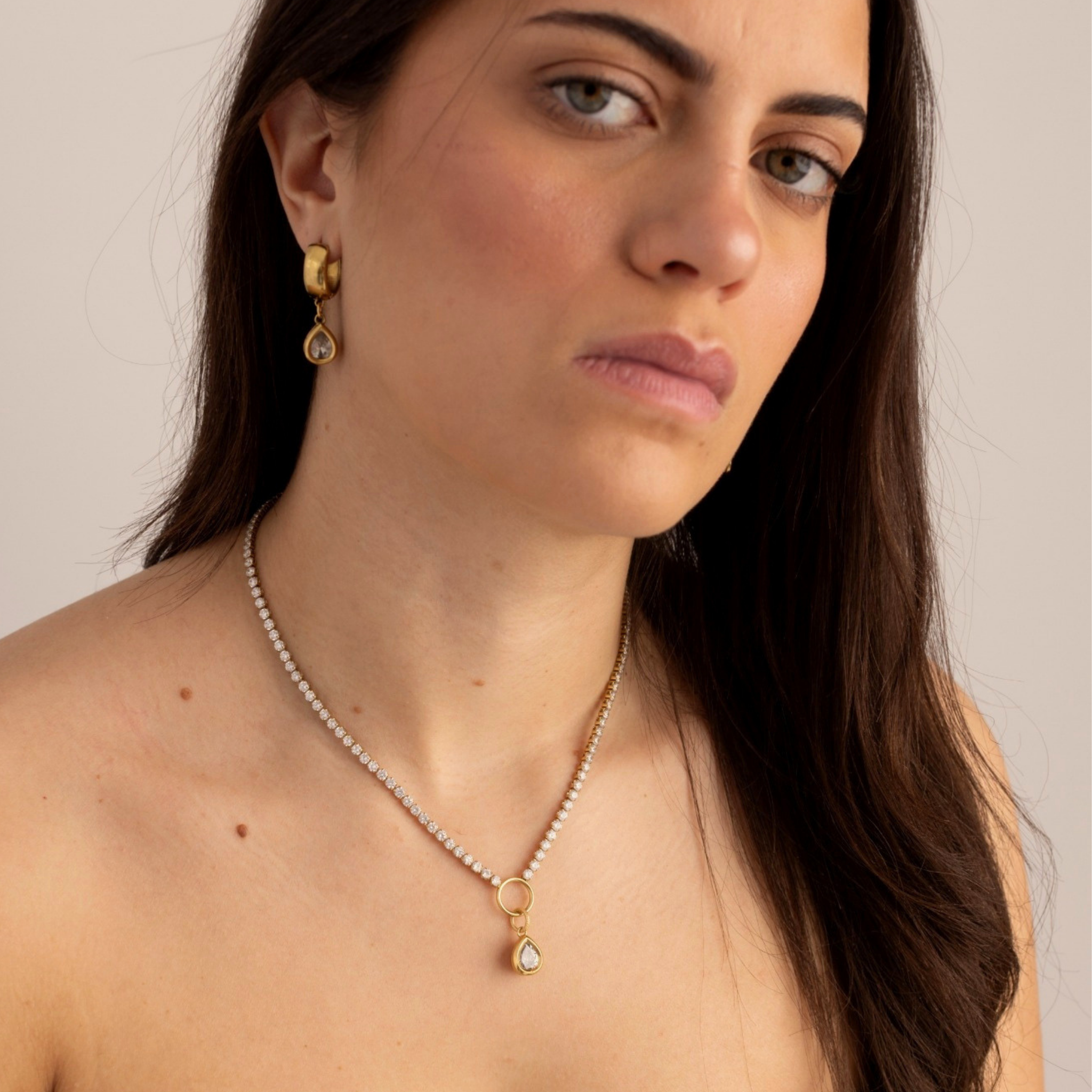 Lanamara Vintage Clarity pear huggie earrings worn with the matching Clarity tennis necklace