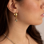Model wearing Lanamara Vintage Clarity pear huggie earrings with the Clarity tennis necklace